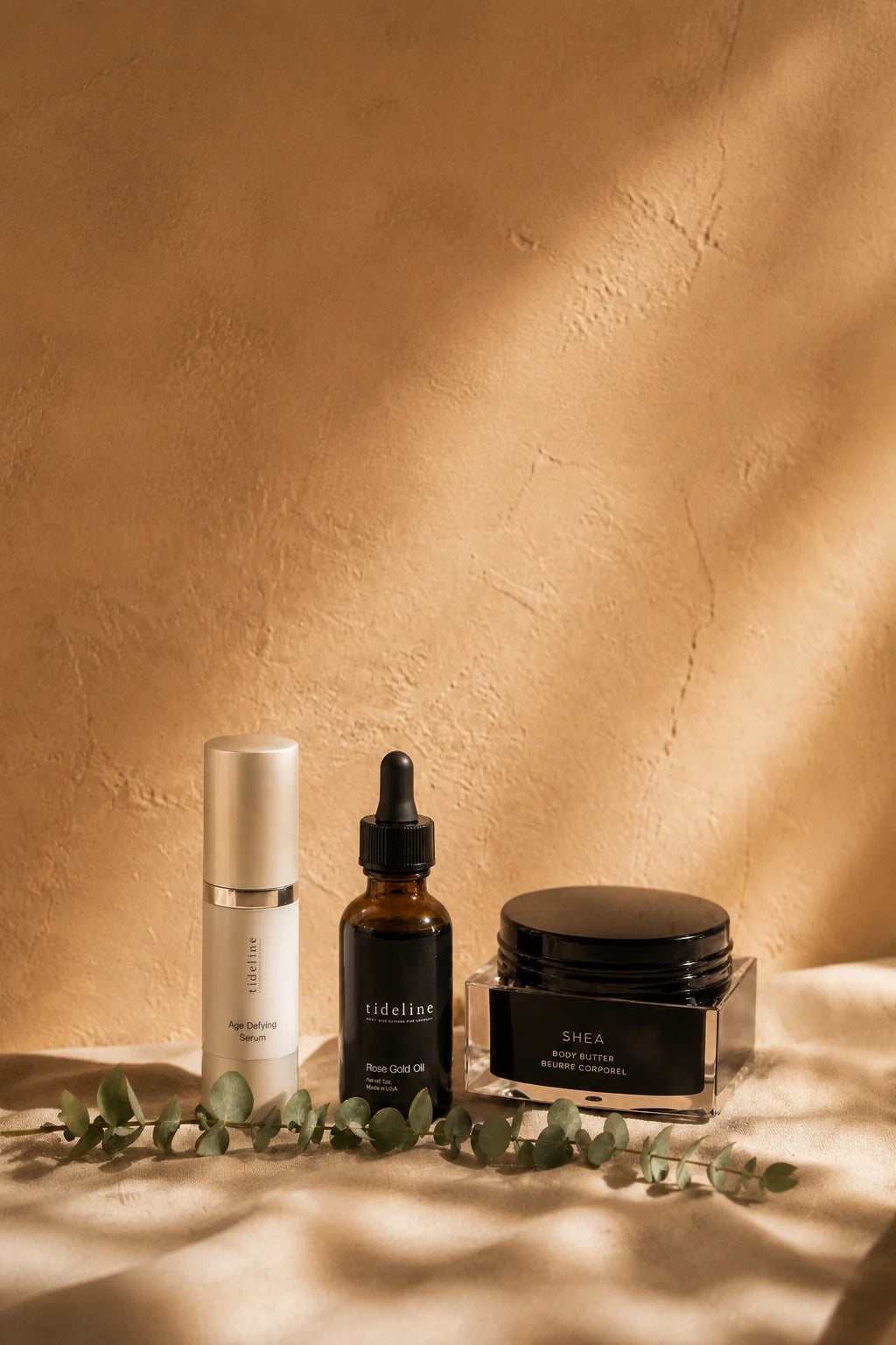 The three Tideline formulas on linen against a warm plaster wall