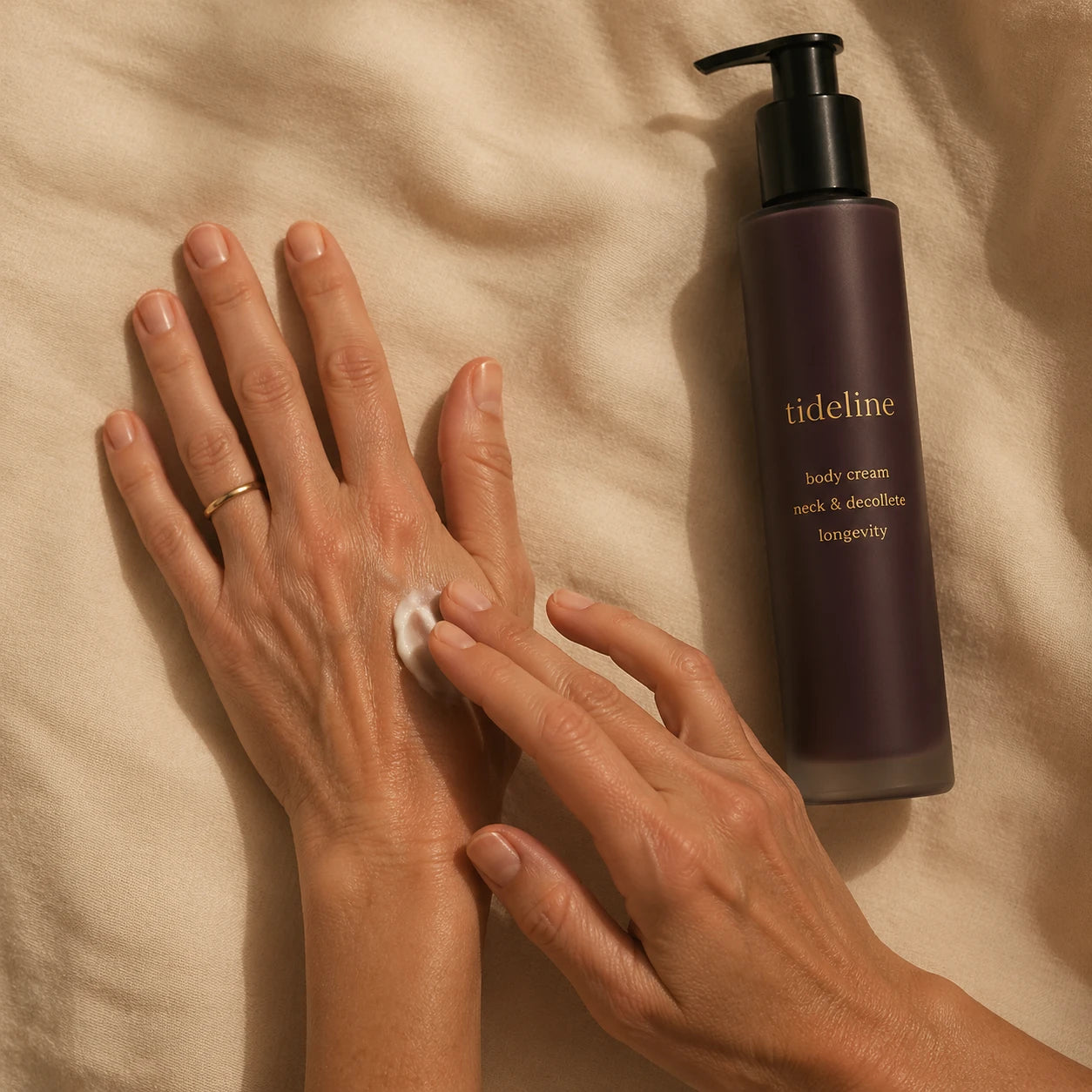 A hand applying daily cream to the back of the other hand