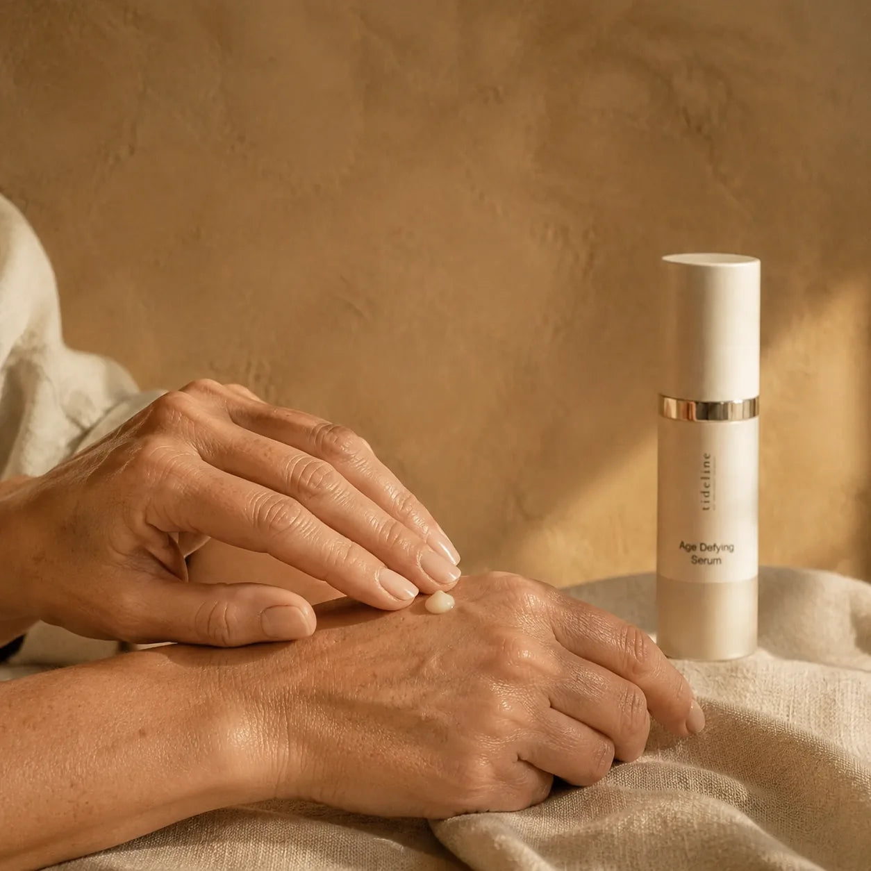Age-Defying Serum being pressed into the back of the other hand