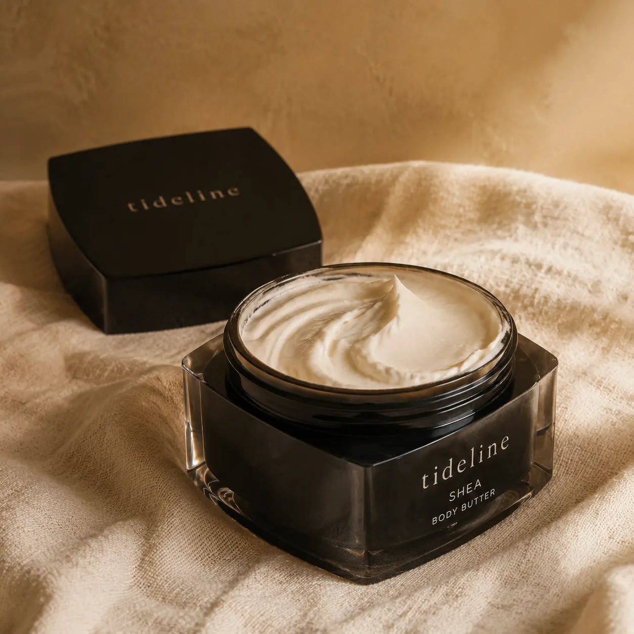 Close texture of a rich body butter, scooped and catching warm light